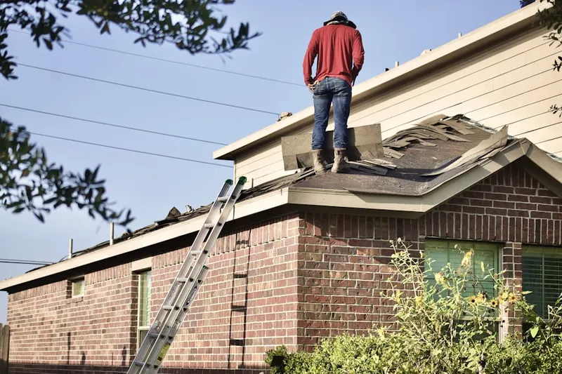 Professional roofer working on a residential roof in Johnsontown